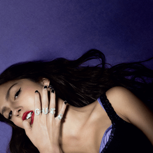 image of young woman in a tank top, against a purple background